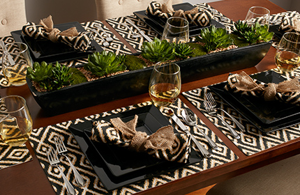 Tribal tableset with greenery and black dishes